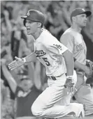  ?? JAYNE KAMIN-ONCEA/USA TODAY ?? Los Angeles Dodgers shortstop Corey Seager (5) rounds first on a walk-off RBI single in the ninth inning against the Reds at Dodger Stadium. in June.