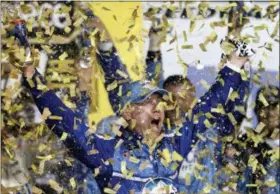  ?? COLIN E. BRALEY — THE ASSOCIATED PRESS ?? Kevin Harvick is covered in confetti as he celebrates winning the NASCAR Cup Series auto race at Kansas Speedway in Kansas City, Kan., Saturday.
