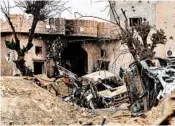  ?? GIUSEPPE CACACE/GETTY-AFP ?? Vehicles and buildings are seen Sunday in the village of Baghouz, Syria, one day after IS was declared defeated.