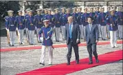  ?? DOUG MILLS / THE NEW YORK TIMES ?? Prime Minister Shinzo Abe of Japan receives President Donald Trump, accompanie­d by a military honor guard, at Akasaka Palace in Tokyo on Monday.