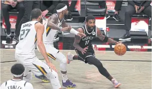  ?? AFP ?? The Nets’ Kyrie Irving, right, drives against the Jazz in Brooklyn.