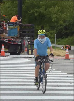  ?? PETE BANNAN — MEDIANEWS GROUP ?? Steve Trobovic of King of Prussia crosses the nine lanes of Route 100 on his bike ride along the Chester Valley Trail.