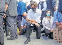  ?? REUTERS ?? Canada's PM Justin Trudeau takes a knee during a rally in Ottawa. n