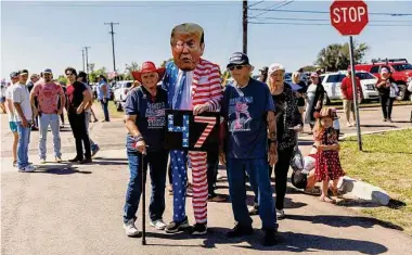  ?? Sam Owens/Staff photograph­er ?? Rusty Lee of Nacogdoche­s, center, poses with people awaiting Donald Trump’s rally Saturday in Waco.