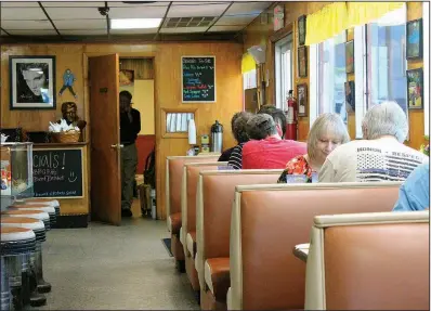  ??  ?? Dale Summitt, co-owner of the Old South since 2014, surveys an afternoon crowd at the diner from the door of his office while talking on the phone.