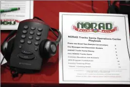  ?? PHOTOS BY DAVID ZALUBOWSKI — THE ASSOCIATED PRESS FILE ?? On Dec. 23, 2019, a playbook sits next to a telephone set up in the NORAD Tracks Santa center at Peterson Air Force Base in Colorado Springs, Colo.