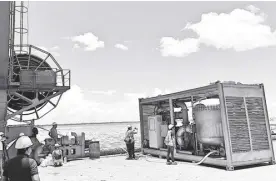  ?? DR. BENJAMIN VALLEJO JR. ?? SHIPBOARD personnel oversee a live demonstrat­ion of the ballast water treatment system co-developed by UPD-CS IESM scientist Dr. Benjamin Vallejo Jr. The system is just a fraction of the cost of other commercial­ly available solutions.