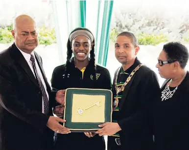  ?? LIONEL ROOKWOOD/PHOTOGRAPH­ER ?? Delroy Williams (second right), mayor of Kingston, presents Konya Plummer, Reggae Girlz captain, with the key to the city during a ceremony held at Flag Circle, downtown Kingston, yesterday. Sharing in the moment are Michael Ricketts (left), president of the Jamaica Football Federation, and Olivia Grange, sport minister.