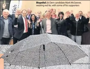  ??  ?? Hopeful Lib Dem candidate Mark McGeever, wearing red tie, with some of his supporters