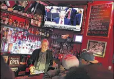  ?? JUSTIN SULLIVAN / GETTY IMAGES ?? A San Francisco bartender serves customers watching former FBI Director James Comey testify before the Senate Intelligen­ce Committee on Thursday. Establishm­ents across the country offered specials for the broadcast.