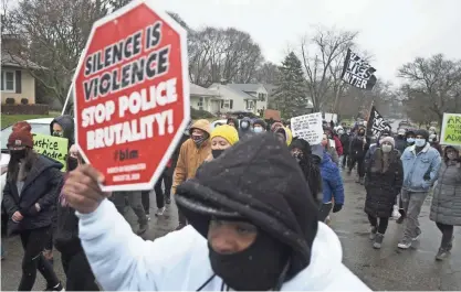  ?? JOSHUA A. BICKEL/COLUMBUS DISPATCH ?? Residents and supporters march up Oberlin Drive during a vigil for Andre Hill on Dec. 24. Hill, a 47-year-old Black man, was shot and killed by a police officer. Hill was unarmed.