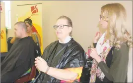  ?? STAFF PHOTOS BY TIFFANY WATSON ?? On Oct. 5, Bridgette Young of Blades School of Hair Design in California, Md., gives La Plata resident Lorene Garner a hair cut at Community Resource Day.