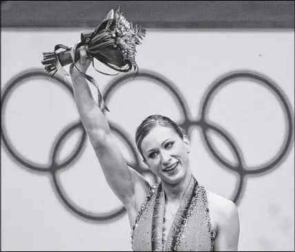  ?? CP PHOTO ?? Joannie Rochette, of Canada, holds her flowers after winning a bronze medal in the women’s figure skating competitio­n at the 2010 Vancouver Olympic Winter Games in Vancouver.