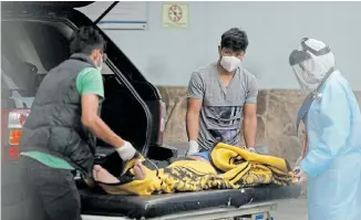  ?? Picture: LUIS ECHEVERRIA/ ?? SAD SITUATION: Relatives of a man sick with the coronaviru­s disease (Covid-19) move him onto a stretcher as a nurse looks on, at the emergency area of the San Juan de Dios hospital, in Guatemala City, Guatemala