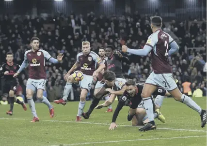  ??  ?? 0 Aaron Ramsay goes down under the challenge of Burnley’s James Tarkowski, but no red card was shown.