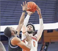  ?? Rich Barnes / USA TODAY Sports ?? Alan Griffin shoots the ball as Buffalo’s Jayvon Graves defends Saturday. Griffin tied his career high with 24 points and added 10 rebounds as the Orange came back from a 57-41 deficit with 16:34 left in regulation to pick up the victory.