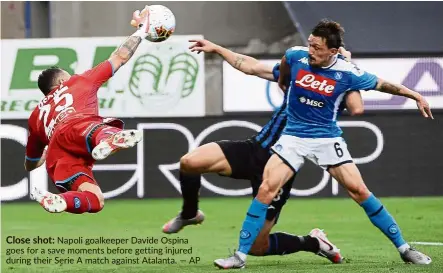  ??  ?? Close shot: Napoli goalkeeper davide Ospina goes for a save moments before getting injured during their Serie a match against atalanta. — aP