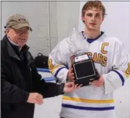  ?? SAM STEWART — DIGITAL FIRST MEDIA ?? Downingtow­n East celebrates after captain Collin Harple collects the trophy following Thursday’s Ches-Mont League final at Ice Line.
