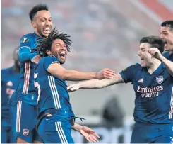  ??  ?? On target: Mohamed Elneny celebrates with team-mates Kieran Tierney and Pierre-emerick Aubameyang after sealing Arsenal’s win