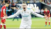  ??  ?? In this May 26, 2018 file photo, Real Madrid’s Gareth Bale celebrates after scoring his side’s second goal during the Champions League final soccer match between Real Madrid and Liverpool at the Olimpiyski­y Stadium in
Kiev, Ukraine. (AP)