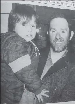  ?? Nugget file photo ?? FIRST IDITAROD— Howard Farley hold his son Howard Jr. coming off the trail of the first Iditarod Trail Sled Dog Race in 1973.