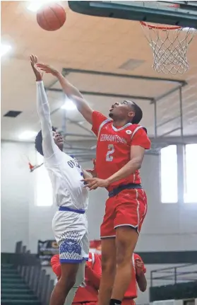  ?? STU BOYD II/THE COMMERCIAL APPEAL ?? Overton’s Xavier Alexander, left, floats a shot over Germantown’s Kaleb Jeffries in the MSCIAA City Championsh­ip game on Feb. 11 at Whitestati­on High School in Memphis.