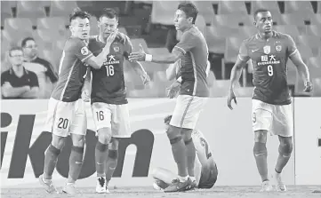  ??  ?? This file photo taken on March 2 shows Guangzhou Evergrande player Huang Bowen (second left) being congratula­ted by teammates after scoring against Sydney FC during their AFC Champions League group stage football match in Sydney. — AFP photo