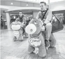  ?? DARREN STONE, TIMES COLONIST ?? Rhys Tiemens, left, and Adam McGuinness ride motorized stuffed animals in Mayfair Shopping Centre.