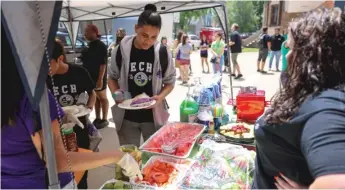  ?? ANTHONY VAZQUEZ/SUN-TIMES ?? ABOVE: Students and staff enjoy burgers and other food to celebrate the last day of school at Peace and Education Coalition Alternativ­e High School at 4946 S. Paulina St. in Back of the Yards on Tuesday.