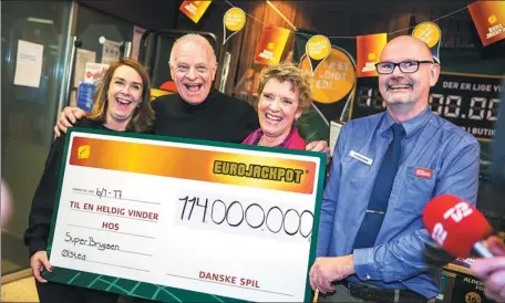  ?? NIKOLAI LINARES / SCANPIX DENMARK VIA AFP ?? New multimilli­onaires Leif and Aase Sommer, who won 114 million euros ($121 million) tax free in the Euro Jackpot lottery, celebrate at the SuperBrugs­en store where they bought the winning coupon, in Oelsted, Denmark, on Wednesday.