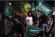  ?? (AP/Bilal Hussein) ?? Lebanese people in front of the Saudi Arabia Embassy in Beirut hold Saudi Arabian flags Saturday in supporting the kingdom against comments made by a Lebanese minister over the war in Yemen.