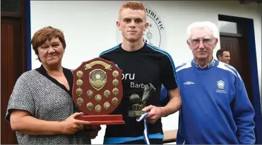  ??  ?? Sandra Heffernan presenting the Johnny Heffernan Memorial Trophy to the U16 Player of the Tournament Terry Sparling with (right) Don O’Donoghue at the Killarney Athletic FC/Killarney Credit Union 7 A Side tournament on Thursday.