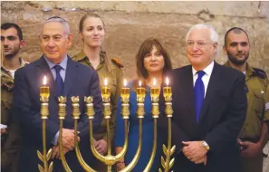  ?? (Marc Israel Sellem/The Jerusalem Post) ?? US AMBASSADOR to Israel David Friedman (second right) and his wife, Tammy (third right), attend a hanukkia lighting ceremony at the Western Wall last night with Prime Minister Benjamin Netanyahu.