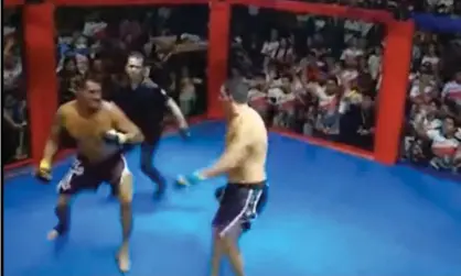  ?? Photograph: Twitter ?? Simão Peixoto and Erineu da Silva fight it out in front of hundreds of paying spectators in the gymnasium of a local school in Borba.