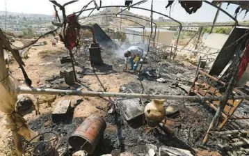  ?? JAAFAR ASHTIYEH/GETTY-AFP ?? A Palestinia­n inspects his damaged belongings Saturday in Al Mughayir in the West Bank.