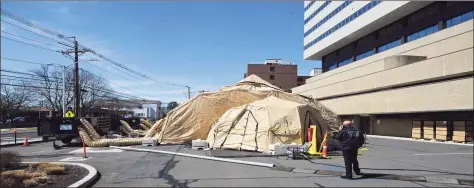  ?? H John Voorhees III / Hearst Connecticu­t Media file photo ?? A 25-bed mobile field hospital was erected outside Danbury Hospital in March as the hospital dealt with the outbreak.