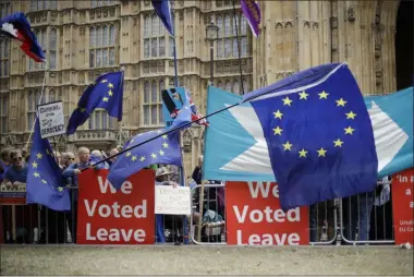  ?? MATT DUNHAM ?? FILE - In this Sept. 3, 2019, file photo, leave and remain supporters try to block each others’ banners as they protest opposite Parliament Square in London. Internet companies say they’re working to fight misinforma­tion ahead of next month’s general election in the United Kingdom, but bogus online claims and misleading political ads remain a threat due to government inaction.