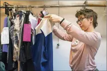  ?? ALYSSA POINTER / ALYSSA.POINTER@AJC.COM ?? Team leader Allie George sorts through consigned clothing at Finders Keepers Fashions in Avondale Estates. The store had more drop-offs than usual in January as customers used the KonMari Method to clear their closets.