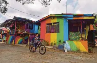  ??  ?? Colourful houses in Kampung Sungai Budor bring an air of freshness and cheer to the idyllic village.