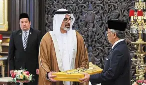  ?? ?? yang di-pertuan agong al-sultan abdullah Ri’ayatuddin al-mustafa Billah Shah conferring the darjah Seri Maharaja Mangku negara (Kehormat) award, which carries the title ‘Tun’, on Crown Prince of abu dhabi, Sheikh Khaled bin Mohamed bin Zayed al nahyan, at Istana negara in May. — Bernama