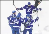  ?? JASON FRANSON — THE CANADIAN PRESS VIA AP ?? The Lightning’ Kevin Shattenkir­k (22) celebrates his goal with teammates during the first period of the Stanley Cup finals against the Dallas Stars in Edmonton, Alberta on Monday.