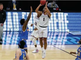  ?? The Associated Press ?? Gonzaga guard Jalen Suggs (1) shoots over UCLA guard David Singleton (34) to win the game during overtime in Saturday’s men’s Final Four NCAA basketball tournament semifinal game at Lucas Oil Stadium in Indianapol­is. Gonzaga won 93-90.