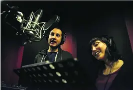  ?? Salah Malkawi for The National ?? Ibrahim Taha and Lina Adnani record their original songs for their educationa­l Arabic cartoon Adam Wa Mishmish in Amman, Jordan.