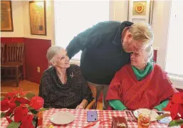  ?? Salgu Wissmath/staff photograph­er ?? Warren Faris, center, greets his aunt Sandra Mathis, right, and mother, Sharon Gregory, at a Pearl Harbor anniversar­y luncheon Thursday at Barn Door restaurant. Faris’ father, Richard Anderson, was a Pearl Harbor survivor.