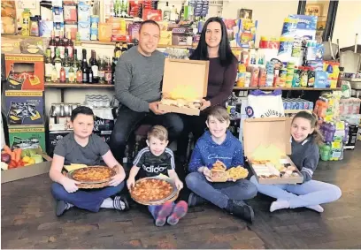  ??  ?? The Black Lion Hotel in Llansawel has been offering takeaway and home delivery meals during the lockdown. Pictured are Simon and Samantha Jones and their children Telina, Callum, Joshua and Lucas.