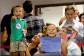  ?? SHANNON STAPLETON / REUTERS ?? Children wave US flags at an election night party for Democratic candidate Danny O’Connor in a special congressio­nal election in Ohio’s 12th District, in Westervill­e, Ohio on Tuesday.