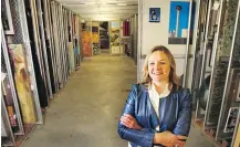  ?? WIL ANDRUSCHAK ?? Melanie Kjorlien, Glenbow vice-president of access, collection­s and exhibition­s, in a storage area at the museum.