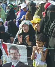  ?? KHALED DESOUKI / AGENCE FRANCE-PRESSE ?? Egyptian women attend a rally organized by the Muslim Brotherhoo­d and supporters of deposed president Mohammed Morsi outside Rabaa al-Adawiya mosque in Cairo on Sunday.