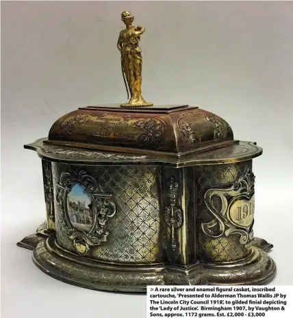  ?? ?? > A rare silver and enamel figural casket, inscribed cartouche, ‘Presented to Alderman Thomas Wallis JP by The Lincoln City Council 1918’, to gilded finial depicting the ‘Lady of Justice’. Birmingham 1907, by Vaughton & Sons, approx. 1172 grams. Est. £2,000 - £3,000