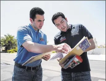  ?? MARTIN S. FUENTES/LAS VEGAS REVIEW-JOURNAL ?? Democrats Nevada Sen. Ruben Kihuen, left, and Nevada Assemblyma­n Nelson Araujo check addresses in Las Vegas while canvassing for votes on Saturday. Kihuen is running in U.S. Congressio­nal District 4. Araujo is running in Nevada Assembly District 3.